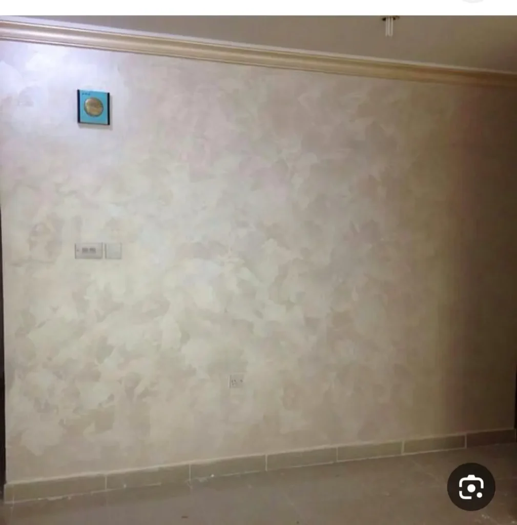 صبغ داخلي بملمس بارز على جدار غرفة في الكويت